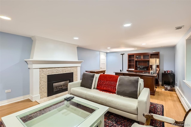 824 S Medea Way, Denver, CO 80209 - living room featuring a baseboard radiator, light wood-style floors, recessed lighting, and a glass covered fireplace