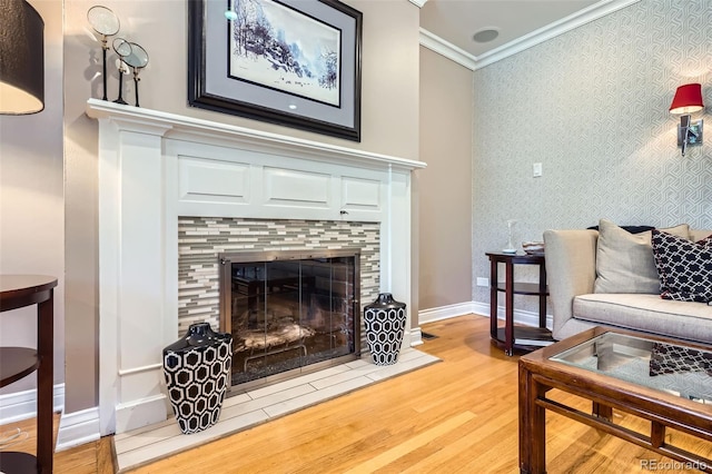 824 S Medea Way, Denver, CO 80209 - living area featuring wood finished floors, wallpapered walls, ornamental molding, and a tiled fireplace
