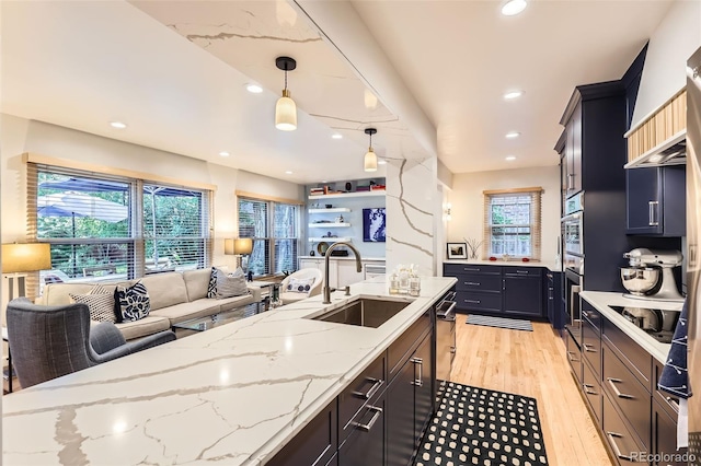 824 S Medea Way, Denver, CO 80209 - kitchen featuring open floor plan, light wood-style flooring, premium range hood, light stone countertops, and recessed lighting