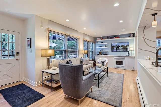 824 S Medea Way, Denver, CO 80209 - living area with light wood-style floors, baseboard heating, and recessed lighting