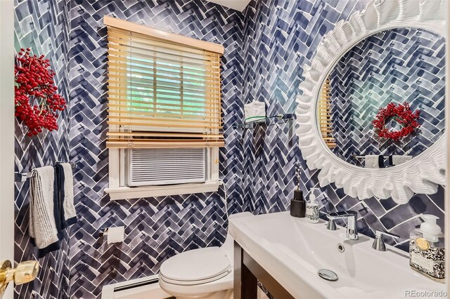 824 S Medea Way, Denver, CO 80209 - half bath with a baseboard radiator, vanity, tile walls, and backsplash