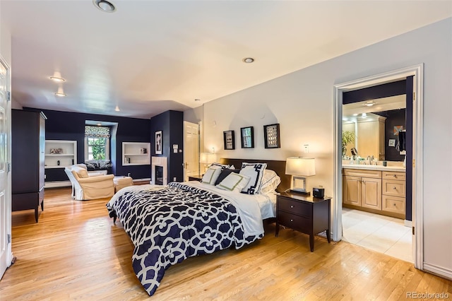 824 S Medea Way, Denver, CO 80209 - bedroom with light wood-style flooring and ensuite bathroom