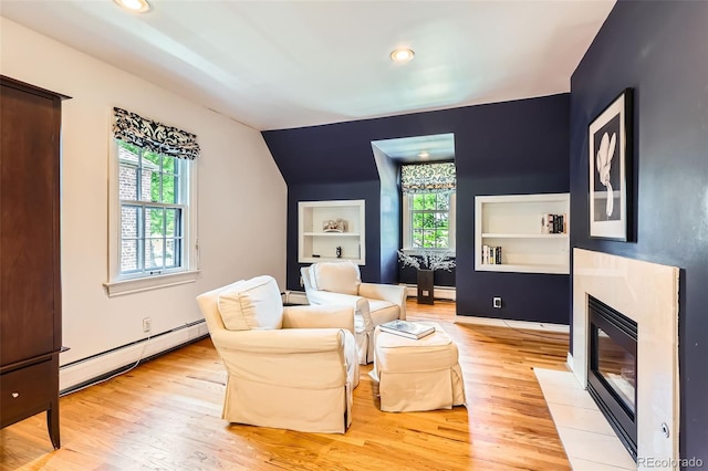 824 S Medea Way, Denver, CO 80209 - sitting room with baseboard heating, built in features, plenty of natural light, light wood finished floors, and lofted ceiling