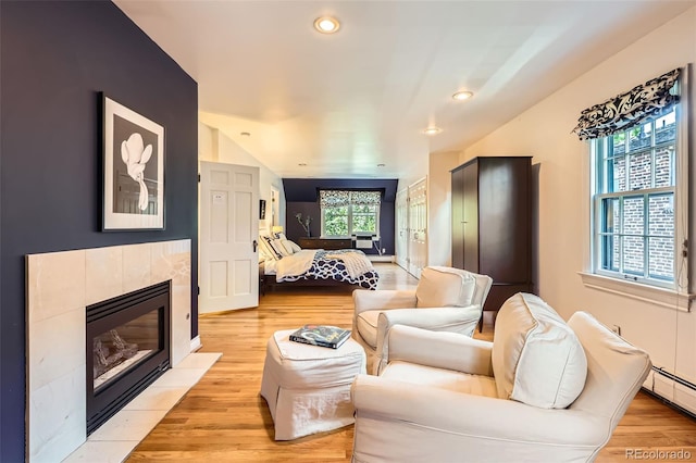 824 S Medea Way, Denver, CO 80209 - living room featuring a baseboard radiator, a fireplace, light wood finished floors, and recessed lighting