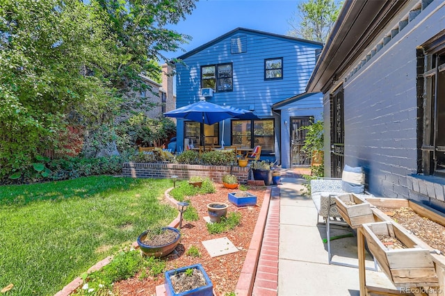 824 S Medea Way, Denver, CO 80209 - rear view of property with a vegetable garden, a lawn, and a patio