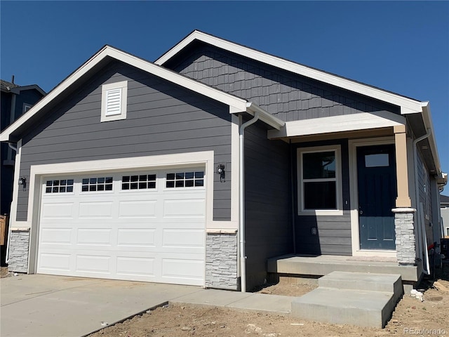 9085 Rifle St, Commerce City, CO 80022 - view of front of property with stone siding, a garage, and driveway