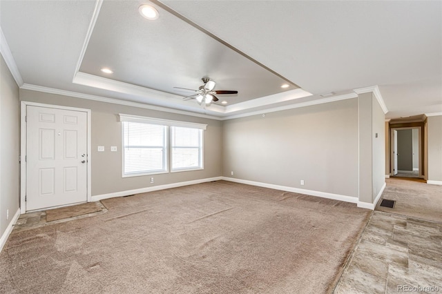 interior space featuring ceiling fan, ornamental molding, and a tray ceiling