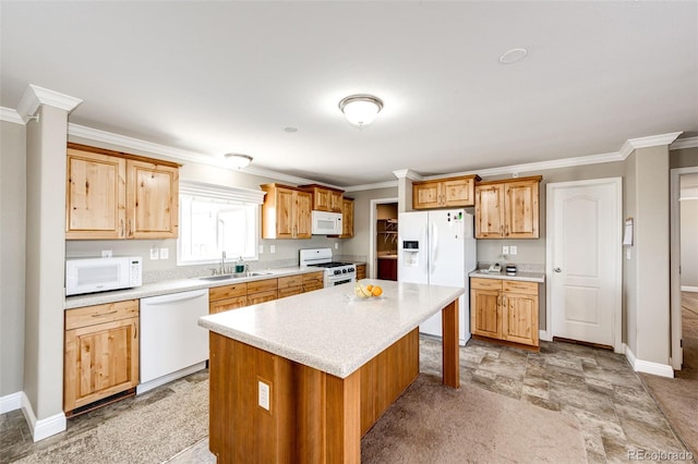 kitchen featuring white appliances, ornamental molding, sink, and a kitchen island