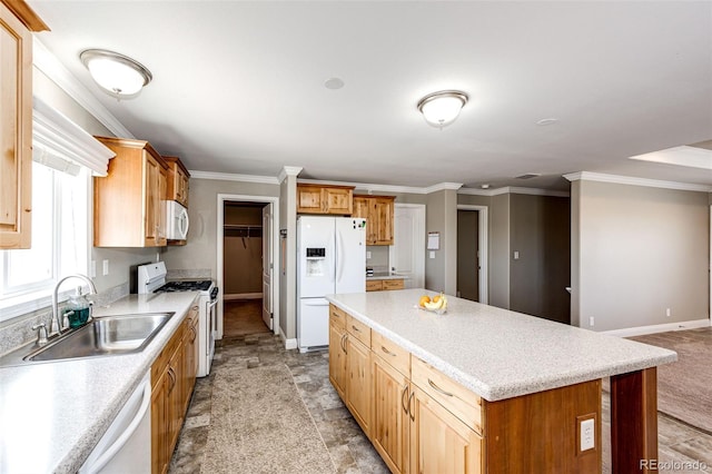 kitchen featuring sink, white appliances, ornamental molding, and a center island