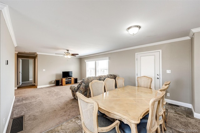 dining area with crown molding, carpet floors, and ceiling fan