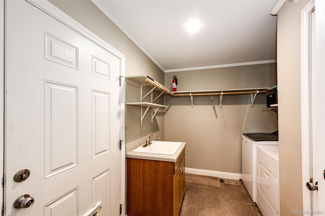 laundry area featuring sink, ornamental molding, washer and dryer, and carpet