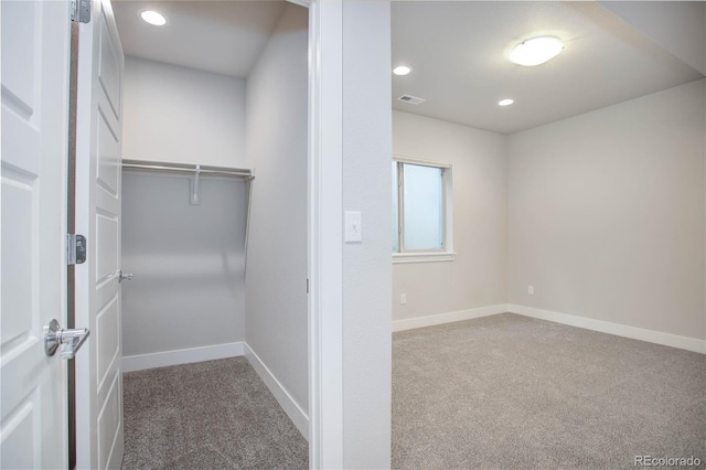 spacious closet featuring carpet and visible vents