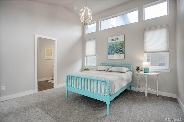 carpeted bedroom featuring an inviting chandelier, high vaulted ceiling, and baseboards