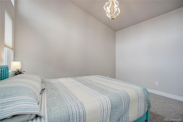 bedroom featuring baseboards, a chandelier, carpet flooring, and vaulted ceiling