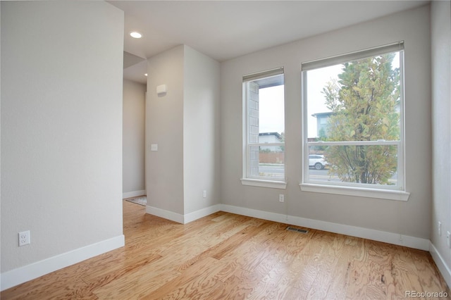 unfurnished room with recessed lighting, baseboards, and light wood finished floors