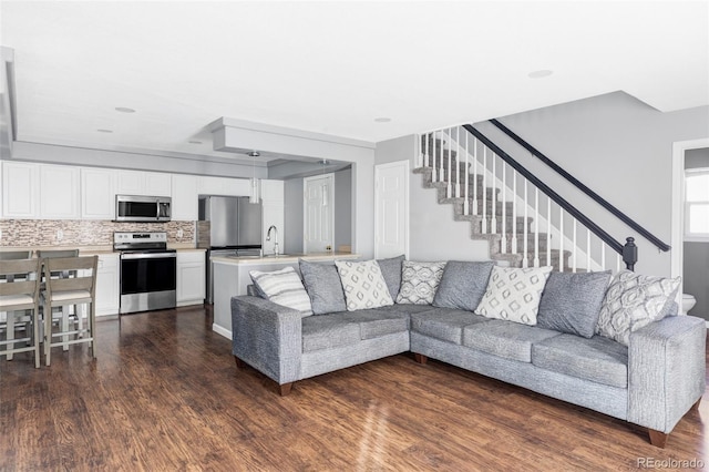 living room with dark hardwood / wood-style floors and sink