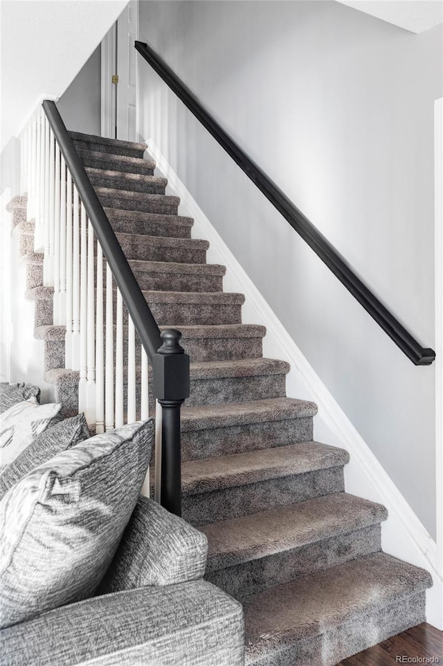 stairs featuring hardwood / wood-style flooring