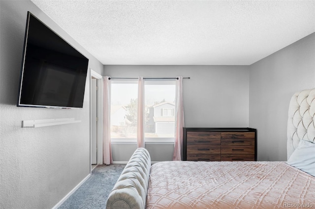 bedroom featuring light colored carpet and a textured ceiling