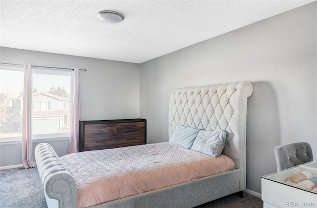 carpeted bedroom with a textured ceiling