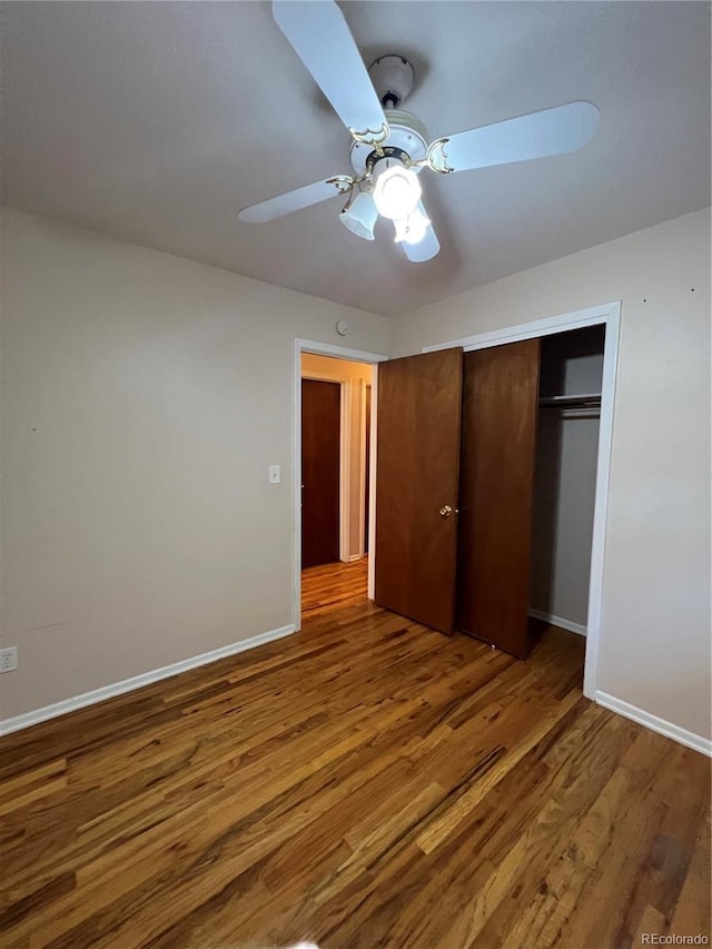 11812 E Alaska Ave, Aurora, CO 80012 - unfurnished bedroom with wood finished floors, a closet, and ceiling fan