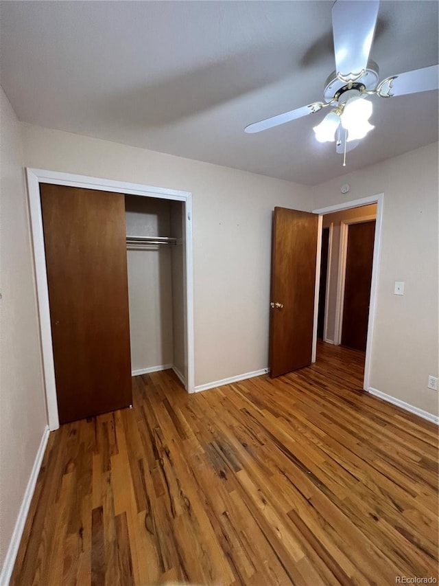11812 E Alaska Ave, Aurora, CO 80012 - unfurnished bedroom with wood finished floors, a closet, and ceiling fan