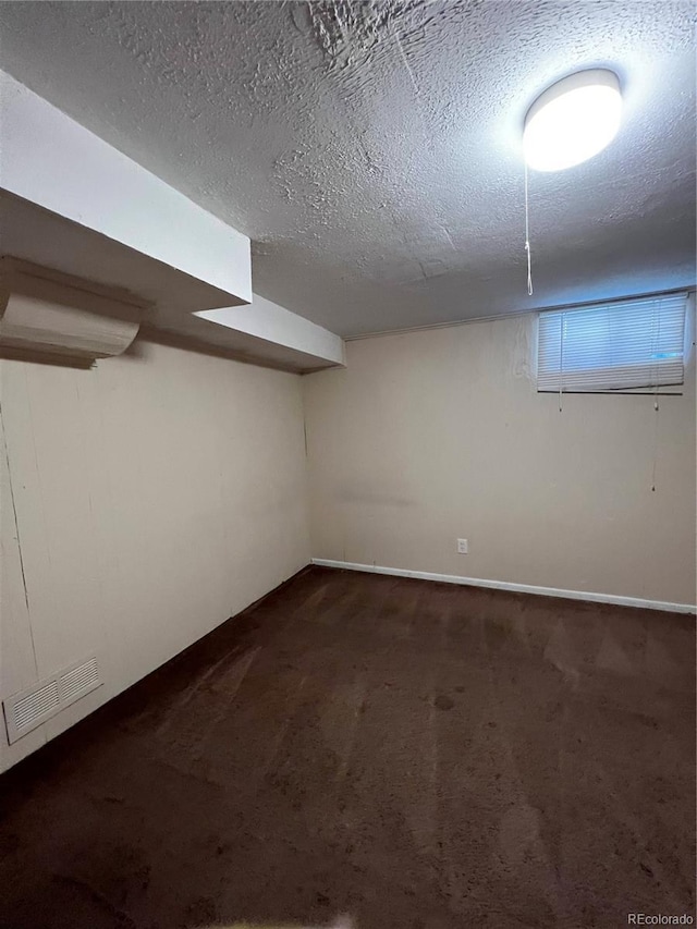 11812 E Alaska Ave, Aurora, CO 80012 - below grade area with dark carpet and a textured ceiling