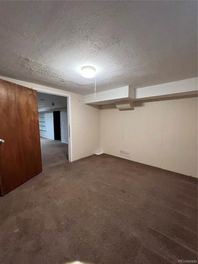 11812 E Alaska Ave, Aurora, CO 80012 - finished below grade area with dark carpet and a textured ceiling