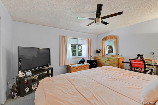 bedroom featuring ceiling fan, carpet floors, and a textured ceiling