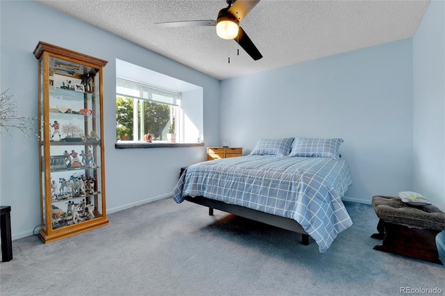 bedroom with light carpet, ceiling fan, and a textured ceiling