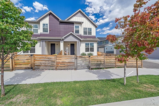 6106 W 28th Ct, Edgewater, CO 80214 - multi unit property featuring board and batten siding, a gate, covered porch, and a fenced front yard