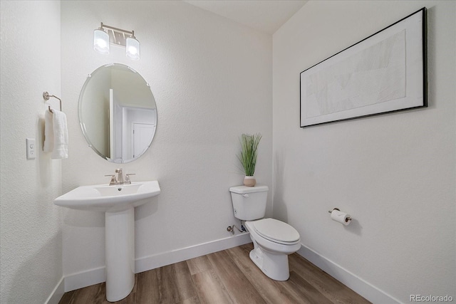 6106 W 28th Ct, Edgewater, CO 80214 - half bathroom featuring wood finished floors and toilet