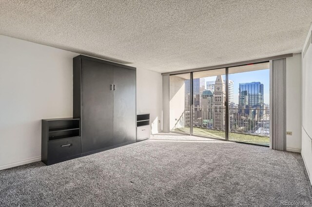 1020 15th St Unit 20F, Denver, CO 80202 - unfurnished bedroom featuring a city view, expansive windows, access to exterior, and carpet floors