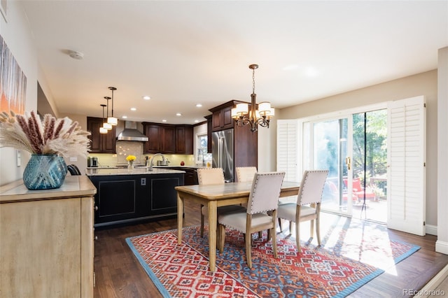 dining space featuring baseboards, a chandelier, dark wood-type flooring, and recessed lighting