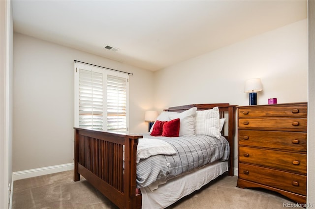 carpeted bedroom with visible vents and baseboards