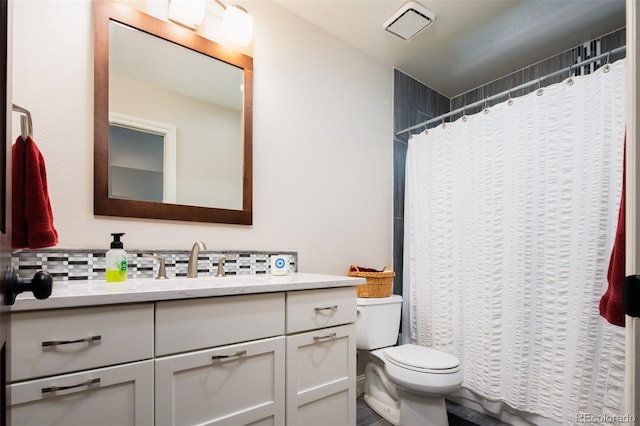 bathroom featuring visible vents, backsplash, toilet, vanity, and a shower with curtain