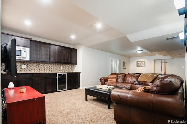 living room featuring wine cooler, light carpet, visible vents, and recessed lighting