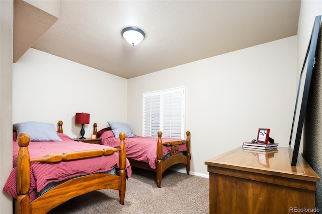 bedroom with carpet and baseboards