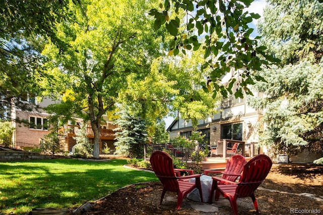 view of yard with an outdoor fire pit and a wooden deck