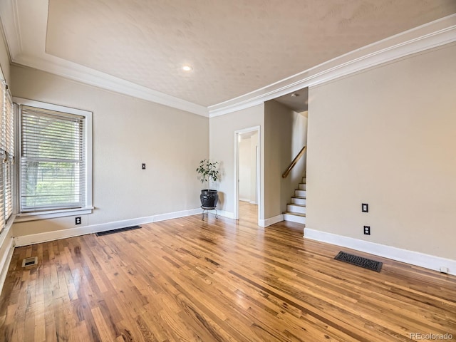5339 S Windermere St, Littleton, CO 80120 - empty room featuring crown molding, stairway, light wood-style flooring, baseboards, and recessed lighting