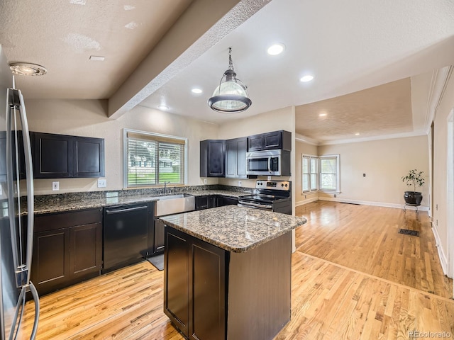 5339 S Windermere St, Littleton, CO 80120 - kitchen featuring appliances with stainless steel finishes, light stone counters, light wood-type flooring, a kitchen island, and recessed lighting
