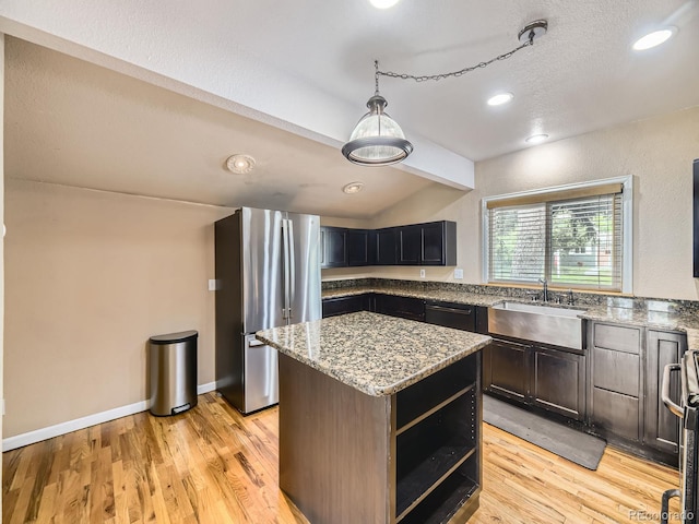 5339 S Windermere St, Littleton, CO 80120 - kitchen featuring freestanding refrigerator, a sink, a center island, light stone counters, and lofted ceiling