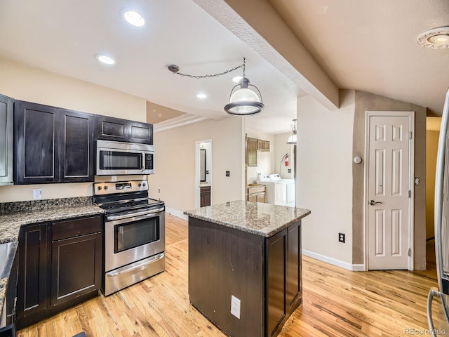 5339 S Windermere St, Littleton, CO 80120 - kitchen with stainless steel appliances, washer and dryer, light wood-type flooring, a center island, and recessed lighting