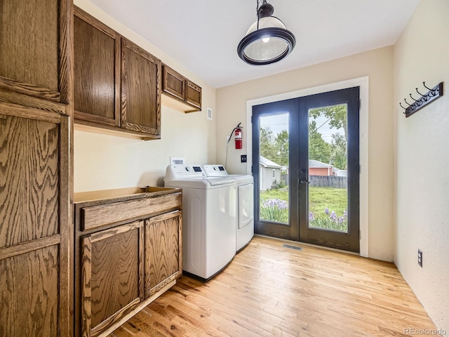 5339 S Windermere St, Littleton, CO 80120 - washroom featuring washer and clothes dryer, french doors, cabinet space, and light wood-style floors