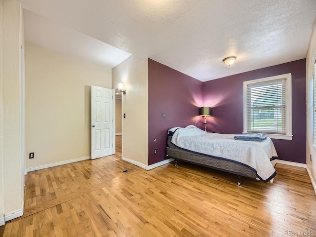 5339 S Windermere St, Littleton, CO 80120 - bedroom featuring light wood-type flooring, a textured ceiling, and baseboards