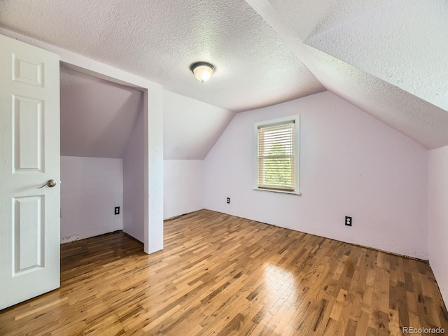 5339 S Windermere St, Littleton, CO 80120 - additional living space featuring light wood finished floors, a textured ceiling, and vaulted ceiling