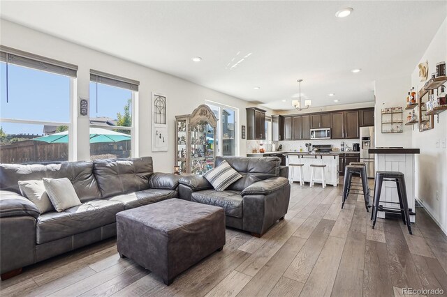 1846 Osprey Dr, Brighton, CO 80601 - living room with wood-type flooring, recessed lighting, and a chandelier