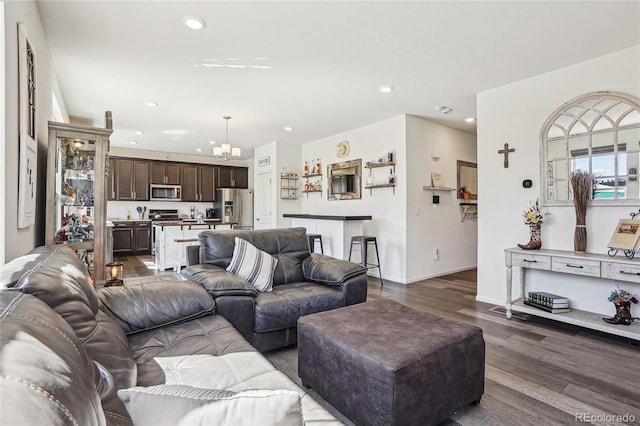 1846 Osprey Dr, Brighton, CO 80601 - living room with recessed lighting, dark wood-style flooring, a chandelier, and baseboards