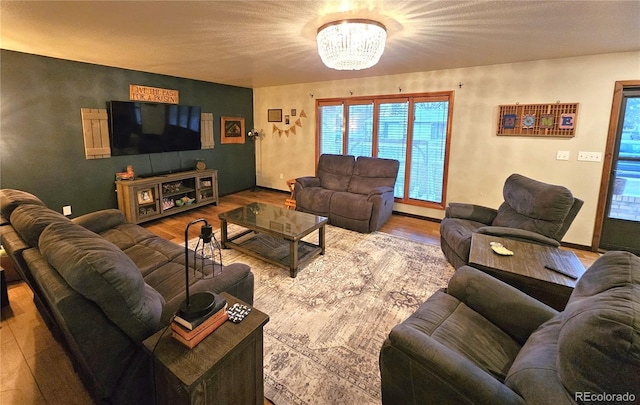 living room featuring an inviting chandelier and wood finished floors