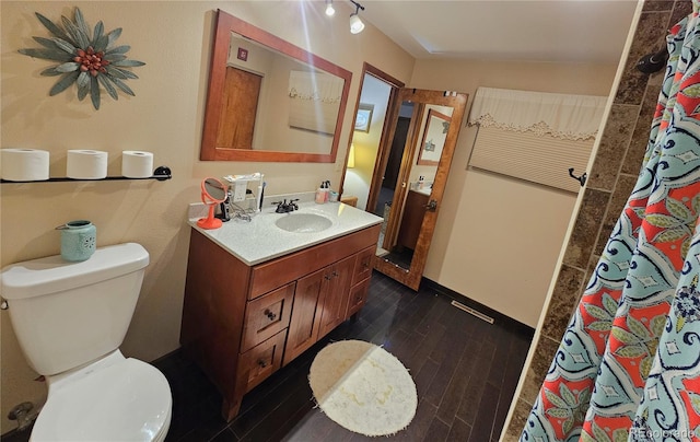 full bath with vanity, wood finished floors, toilet, and a shower with curtain