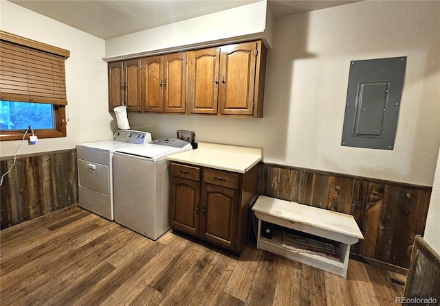 laundry room featuring electric panel, dark wood-style floors, cabinet space, and washer and dryer